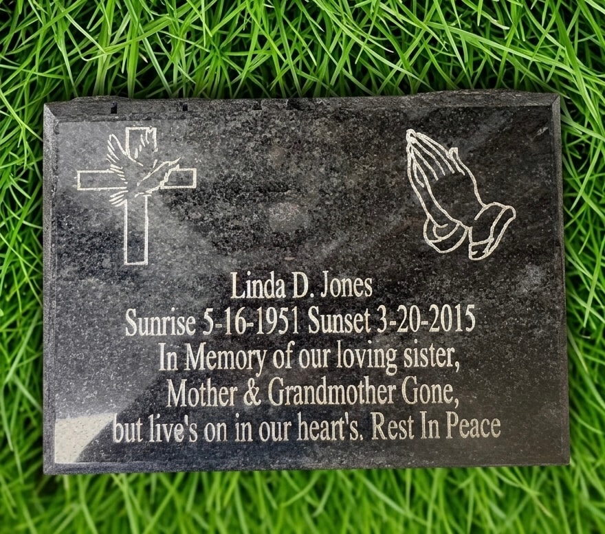 Granite headstone laser engraving — Linda D. Jones memorial with cross and praying hands design